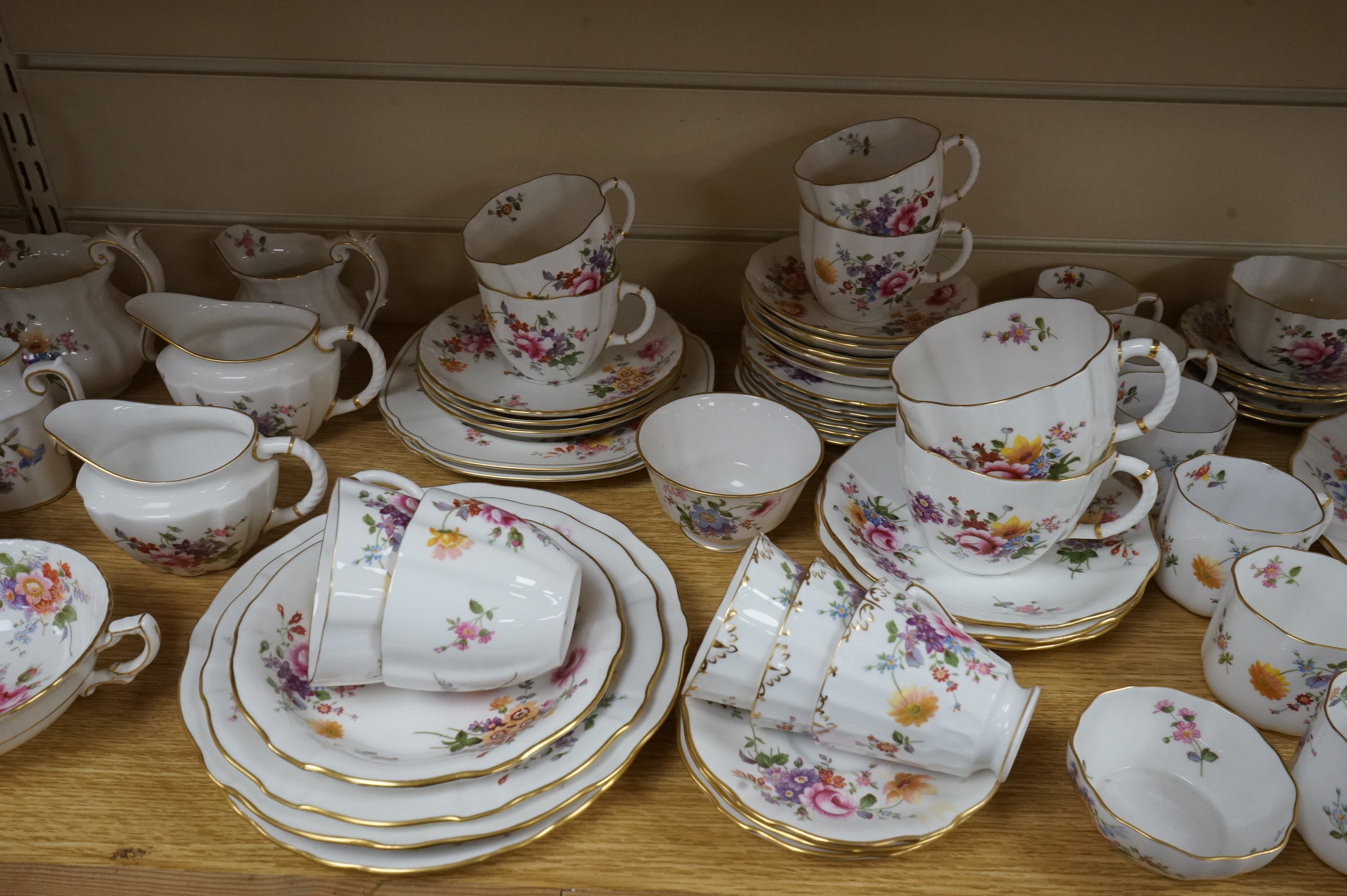An extensive Crown Derby Posies pattern service to include trios, teapot, jugs and miniatures